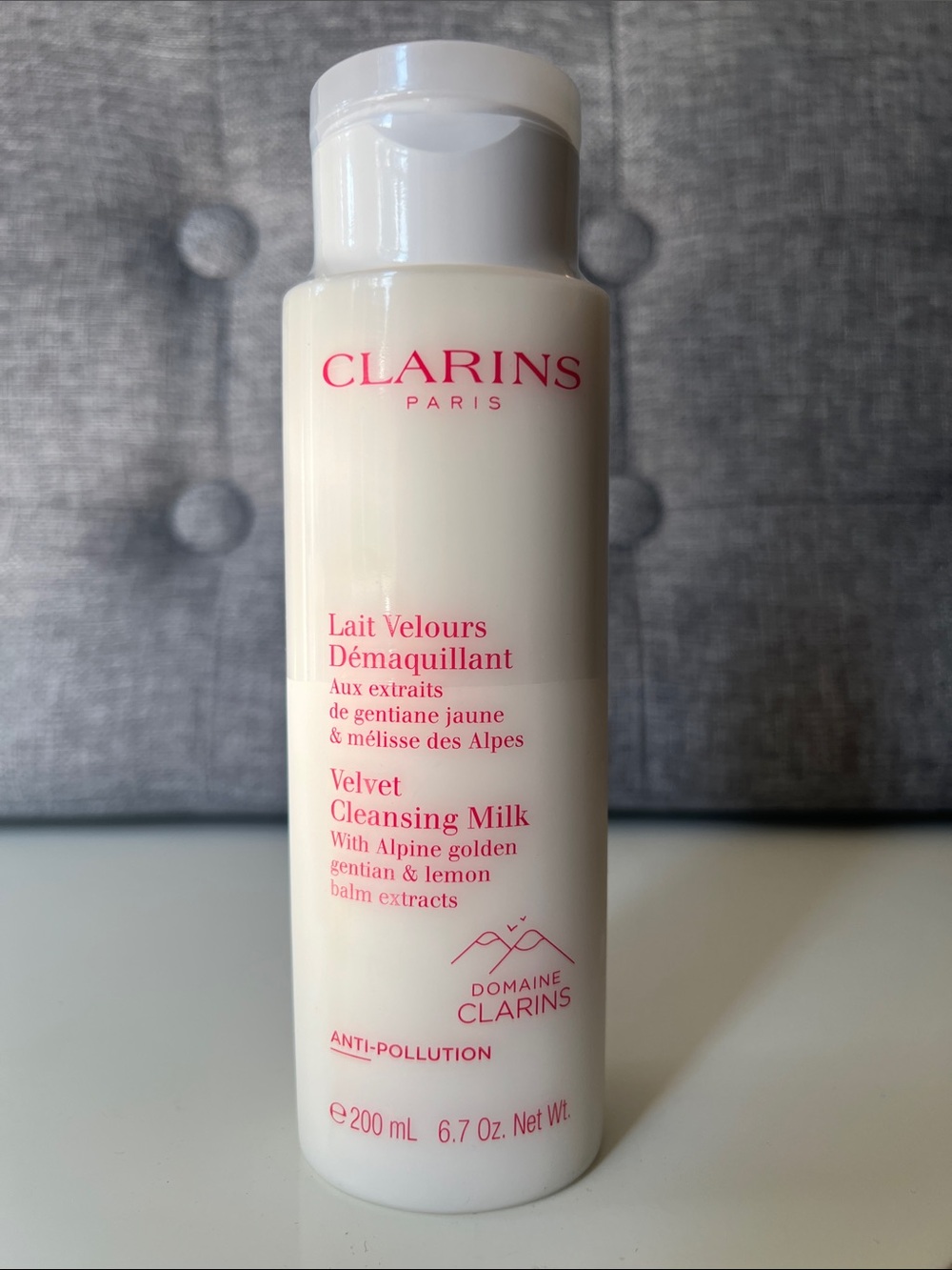 Clarins Velvet Cleansing Milk - Cream with Pink Text